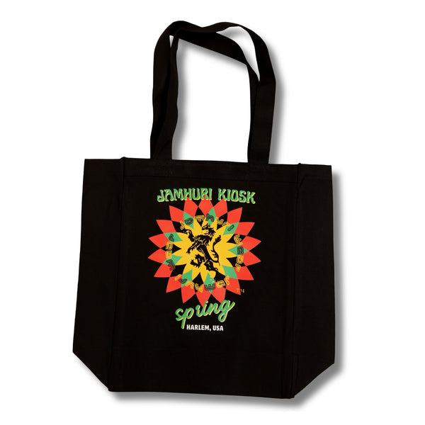 Black tote bag with colorful lotus flower blooming and black lion design and jamhuri kiosk text on a white background
